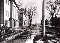 Main Street, Bethel c. 1900 .....This photo shows Main St. with the tracks of the old Shepaug Railroad connecting line running along its north side. This railroad line, which could take passengers from the Bethel Station at Deport place to the main line of the Shepaug at Hawleyville, Newtown, began service on July 4, 1872, and was actually owned by the Danbury and Norwalk Railroad, although most Bethelites referred to it as the Shepaug line. The line was abandoned, except for a service spur serving some Bethel businesses, in July of 1911. The building, now occupied by the Bethel Historical Society and the V.F.W as well as the Congregational Church can be seen at the left.                                                                                                                             