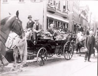 Governor’s Visit to Bethel c.1900....  A visit by Governor George E. Lansbury of Ridgefield, in office from 1899-1901. The carriage is stopped in front of the building that today houses a fitness center. The gentleman seated to the right of the Governor is Dr. William C. Wile, who is responsible for building Tarrywile Mansion. The individual standing to the right of the carriage is Rev. Henry L. Slack, who served as minister of Bethel’s Congregational Church from 1883 until his death in 1905.       